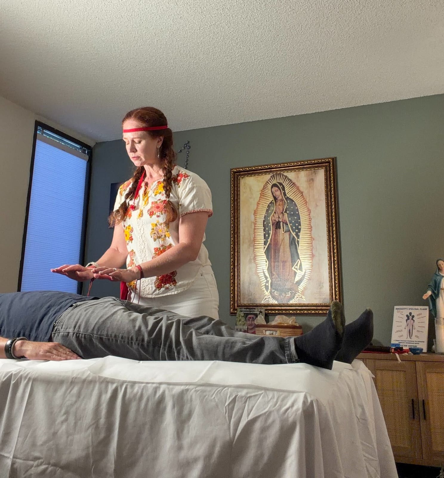 Marilyn performing a spiritual cleansing and healing session on a client in her Brea studio